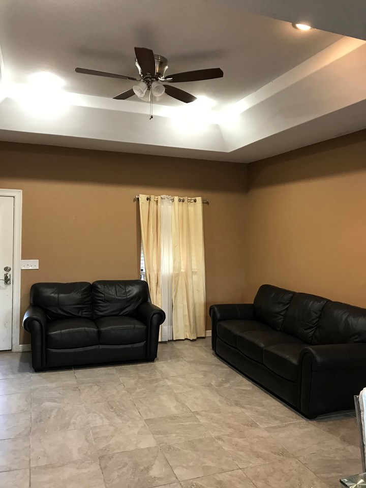 open living area with decorative ceilings