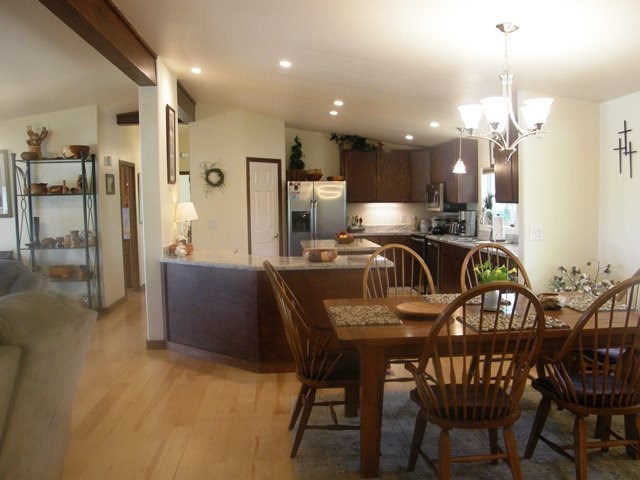 dining kitchen area stainless steel appliances including trash compactor and dishwasher. kitchen island and granite counter tops make it complete. ceiling fans throughout with central air conditioning and heating.