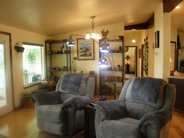 open concept living room, dining and kitchen. there are new large oversized/tinted windows and coverings though out the house for lovely views of the arroyo.