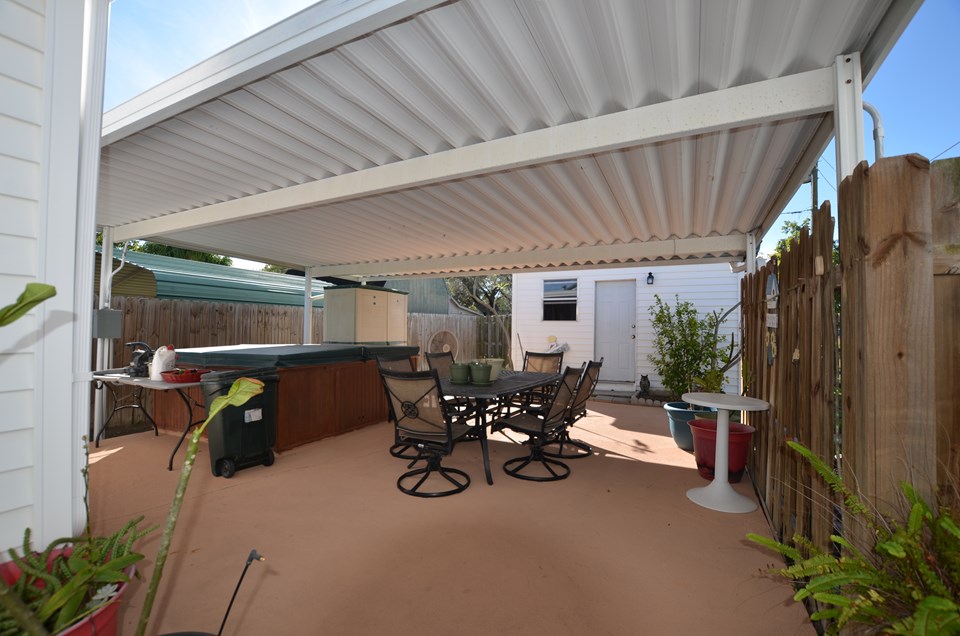 covered patio with hot tub